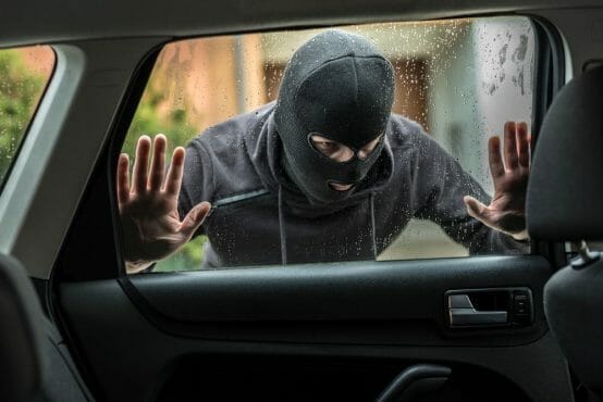 Car thief looking through car window Car Thief Looking Through Car Window
