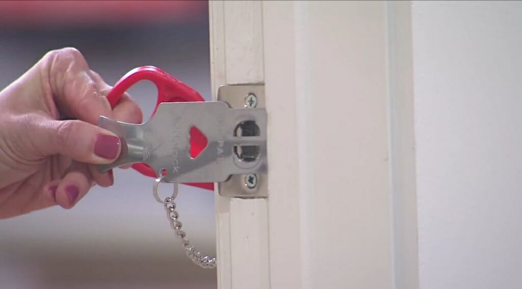 woman inserting the portable door lock steel plate